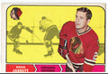 Vintage hockey trading card featuring Doug Jarrett of the Chicago Blackhawks on a yellow background with black and red accents.